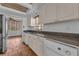 Kitchen featuring granite countertops, white cabinetry, and stainless steel appliances at 1001 Pearce Dr # 106, Clearwater, FL 33764