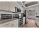 Kitchen with stainless steel appliances, granite countertops, and terracotta tile flooring at 1001 Pearce Dr # 106, Clearwater, FL 33764