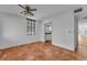 Bright room with terracotta tile flooring, ceiling fan and a pass-through to the kitchen at 1001 Pearce Dr # 106, Clearwater, FL 33764