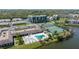 Aerial view of community featuring pool, tennis courts, and scenic lake at 10038 62Nd N Ter # 1, St Petersburg, FL 33708