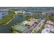 Scenic aerial view showcasing waterfront condos, pool, tennis courts, and lush landscaping at 10038 62Nd N Ter # 1, St Petersburg, FL 33708