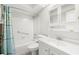 Bright bathroom with white tile, shower-tub combo, grab bar, and mirrored medicine cabinet at 10038 62Nd N Ter # 1, St Petersburg, FL 33708