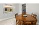 Dining area with wood table and chairs, tile floors, and large window with outdoor views at 10038 62Nd N Ter # 1, St Petersburg, FL 33708