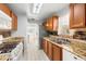 Bright kitchen with granite counters, stainless steel appliances, double sink, and a window for natural light at 10038 62Nd N Ter # 1, St Petersburg, FL 33708