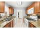 Bright kitchen featuring granite countertops, stainless steel appliances, and a sunlit window with views at 10038 62Nd N Ter # 1, St Petersburg, FL 33708