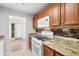 Updated kitchen with granite counters, gas range, microwave and hardwood cabinets offering ample storage at 10038 62Nd N Ter # 1, St Petersburg, FL 33708