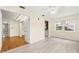 Bright living room with white walls, wood-look floors, ceiling fan and views to additional rooms at 10038 62Nd N Ter # 1, St Petersburg, FL 33708