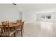 Spacious open-concept living room with neutral tile floors, large windows and dining area at 10038 62Nd N Ter # 1, St Petersburg, FL 33708