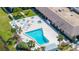 Aerial shot of pool with ample seating and lush landscaping near a lake at 10038 62Nd N Ter # 1, St Petersburg, FL 33708