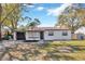 Charming single-story home featuring a freshly painted exterior, attached garage, and neat landscaping at 10512 N Otis Ave, Tampa, FL 33612