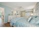 Light and airy main bedroom showcases hardwood floors and light blue walls at 10722 Footprint Ln, Port Richey, FL 34668