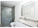 Modern bathroom with a glass-enclosed shower, granite countertop vanity, and sleek fixtures at 114 25Th E St, Palmetto, FL 34221