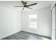 Sunlit bedroom featuring wood-look flooring, a modern ceiling fan, and a bright window at 114 25Th E St, Palmetto, FL 34221