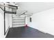 Spacious two car garage featuring black epoxy flooring, ample ceiling height, and an automatic door opener at 114 25Th E St, Palmetto, FL 34221