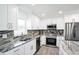Modern kitchen with stainless steel appliances, elegant countertops, and ample storage space in white cabinetry at 114 25Th E St, Palmetto, FL 34221