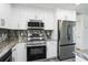 Modern kitchen featuring stainless steel appliances, ample cabinetry, and elegant countertops at 114 25Th E St, Palmetto, FL 34221
