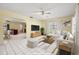 Staged living room featuring an open floor plan, neutral decor, and tile flooring at 11845 Meadowdale Dr, Tampa, FL 33625