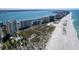 Stunning aerial view of a beachfront community with condos, pools, and easy beach access at 1200 Gulf Blvd # 902, Clearwater Beach, FL 33767