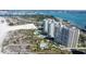 Aerial view of a coastal neighborhood with multiple condo buildings and swimming pools by the sea at 1200 Gulf Blvd # 902, Clearwater Beach, FL 33767