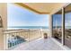 Serene balcony view of the ocean, a resort pool, and a tennis court at 1200 Gulf Blvd # 902, Clearwater Beach, FL 33767