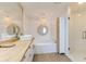 Bright bathroom with double sinks, a soaking tub, and a glass-enclosed shower at 1200 Gulf Blvd # 902, Clearwater Beach, FL 33767