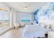 Bright bedroom with ocean view, light hardwood floors and all white decor at 1200 Gulf Blvd # 902, Clearwater Beach, FL 33767