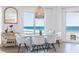 Bright dining area with modern decor, chandelier, and a large window with beach views at 1200 Gulf Blvd # 902, Clearwater Beach, FL 33767