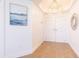 Bright entryway features wood floors, stylish light fixture, decorative mirror, and artwork at 1200 Gulf Blvd # 902, Clearwater Beach, FL 33767