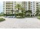 Condominium parking area featuring meticulously landscaped areas and paved pathways at 1200 Gulf Blvd # 902, Clearwater Beach, FL 33767