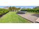 Grassy backyard featuring a trampoline and lush landscaping at 12225 Lake Blvd, New Port Richey, FL 34655