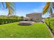 Backyard view showcasing a trampoline, gazebo and manicured lawn at 12225 Lake Blvd, New Port Richey, FL 34655