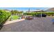 Spacious backyard patio area with brick pavers, gazebo, outdoor seating, and vibrant green landscaping at 12225 Lake Blvd, New Port Richey, FL 34655