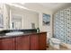 Bathroom featuring a vanity with dark countertop, and a shower/tub combo at 12225 Lake Blvd, New Port Richey, FL 34655