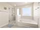 Bright bathroom featuring a glass-enclosed shower and a separate soaking tub at 12225 Lake Blvd, New Port Richey, FL 34655