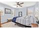 Inviting bedroom with hardwood floors, soft blue walls, and a plush bed, creating a cozy and relaxing atmosphere at 12225 Lake Blvd, New Port Richey, FL 34655