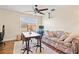 Bedroom featuring a table, a floral sofa, a ceiling fan, and a window that provides natural light at 12225 Lake Blvd, New Port Richey, FL 34655