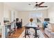 Bonus room featuring hardwood floors, lots of sunlight, multiple desks and chairs, and a ceiling fan at 12225 Lake Blvd, New Port Richey, FL 34655