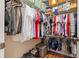 Walk-in closet with organized hanging clothes, shelving, and storage containers for maximum space utilization at 12225 Lake Blvd, New Port Richey, FL 34655