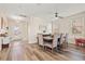 Bright dining area with wood-look flooring and a view to the front entry at 12225 Lake Blvd, New Port Richey, FL 34655