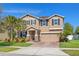 Inviting two-story home featuring a brick driveway, well-manicured lawn, and attractive curb appeal at 12225 Lake Blvd, New Port Richey, FL 34655