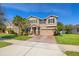 A two-story home with neutral exterior, paver driveway, well-maintained lawn, and mature landscaping at 12225 Lake Blvd, New Port Richey, FL 34655