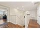 Hallway with hardwood floors leads to a study and a storage area at 12225 Lake Blvd, New Port Richey, FL 34655