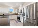 Bright kitchen featuring stainless steel appliances, white cabinets, and a large island with a granite countertop at 12225 Lake Blvd, New Port Richey, FL 34655