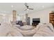Spacious living room showcasing a large sectional sofa, stone columns, and an open layout at 12225 Lake Blvd, New Port Richey, FL 34655