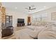 Spacious living room with wood-look flooring, a ceiling fan, and natural light at 12225 Lake Blvd, New Port Richey, FL 34655