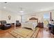 Spacious main bedroom showcasing hardwood floors, a ceiling fan and sitting area at 12225 Lake Blvd, New Port Richey, FL 34655
