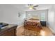Comfortable bedroom with hardwood floors, ceiling fan, and ample natural light at 13140 Village Chase Cir # 13140, Tampa, FL 33618