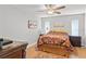 Bedroom featuring light-colored walls, ceiling fan, and two windows for ample light at 13140 Village Chase Cir # 13140, Tampa, FL 33618