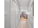 Hallway view with tiled floor and white doors, leading into an open living area at 13140 Village Chase Cir # 13140, Tampa, FL 33618