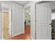 Hallway view showcasing hardwood floors and doorways leading to other rooms at 13140 Village Chase Cir # 13140, Tampa, FL 33618